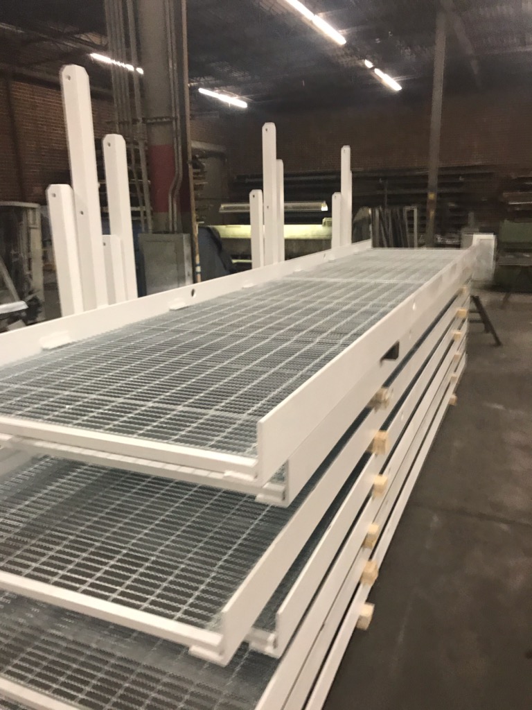 Walkway sections with handrail posts fabricated in shop